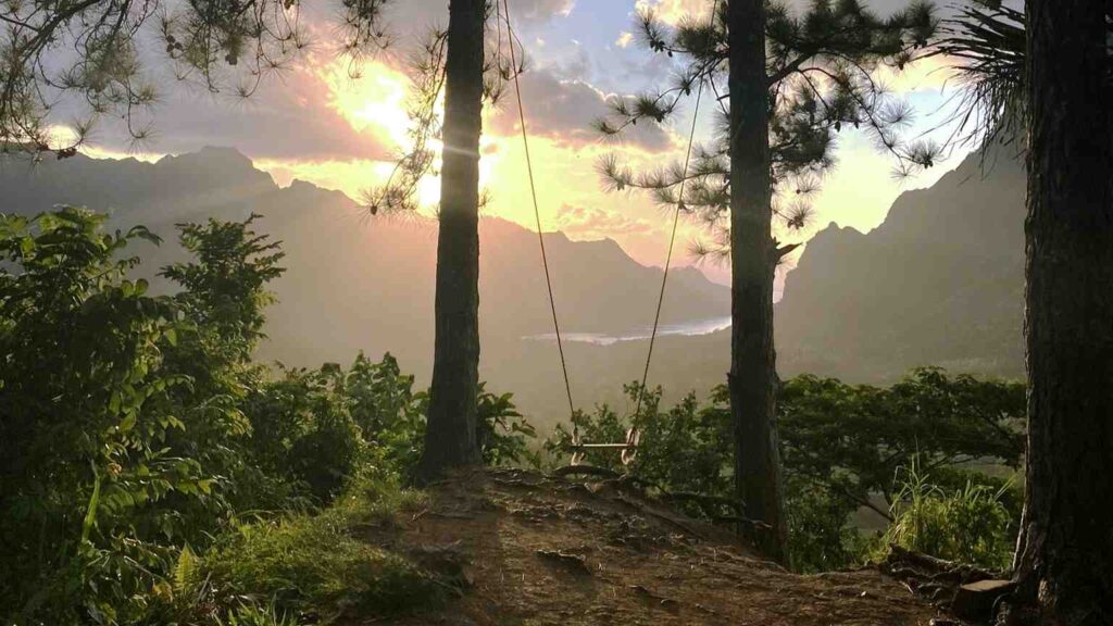 Three Pines Trail view of sunset and a swing